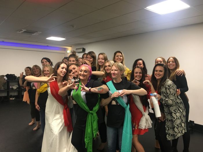 Group of women in colourful saris performing Bollywood choreography at Glasgow Dance Centre hen party class