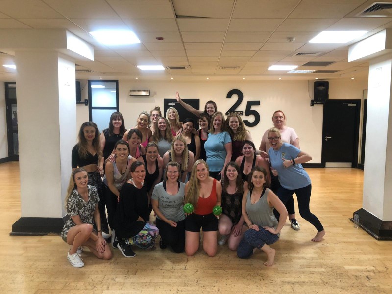 Group of women in romantic attire enjoying Dirty Dancing hen party dance class at Glasgow Dance Centre studio